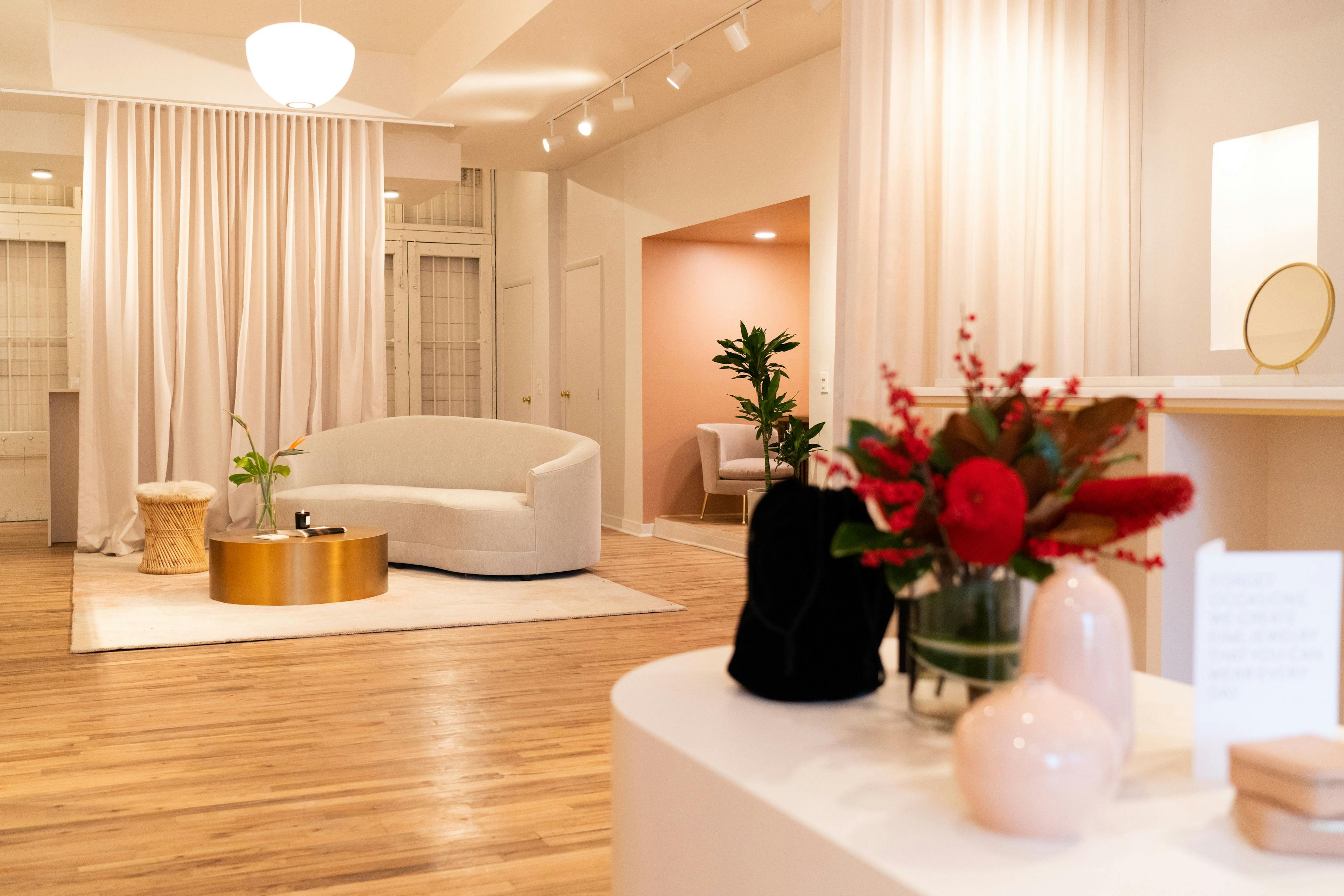 Luxurious Mejuri NYC Flagship store interior design with diaphanous drapes, curved furnishings, and neutral palette.