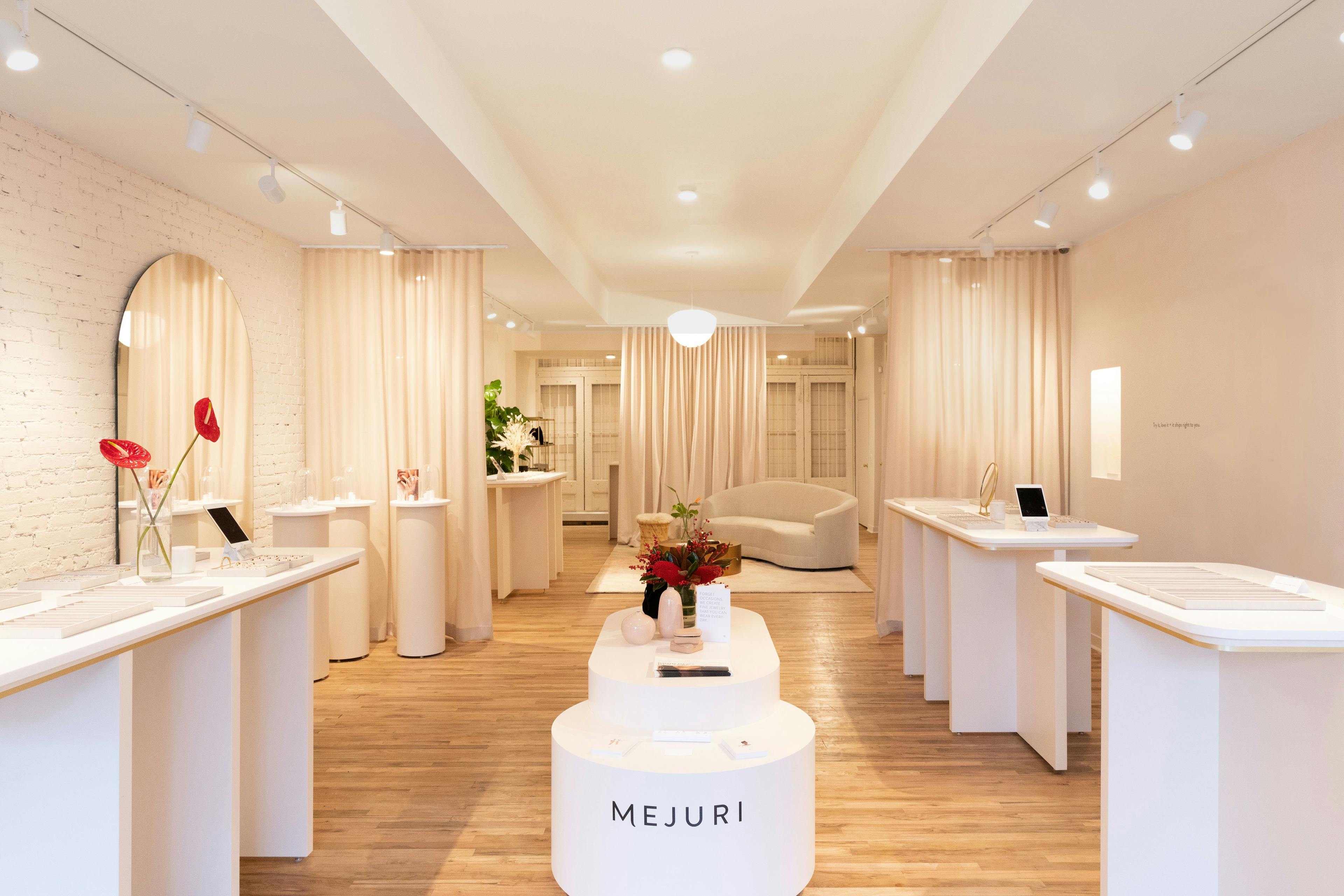 Interior of Mejuri NYC Flagship store featuring everything collection, fine jewelry, bridal boutique, private appointments, and event space with elegant, minimalist design.